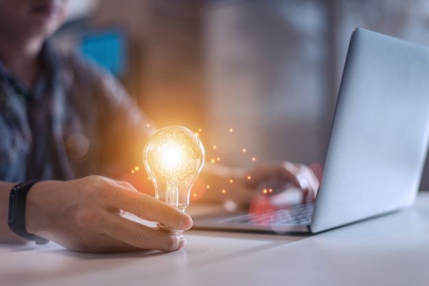 Business man holding light 