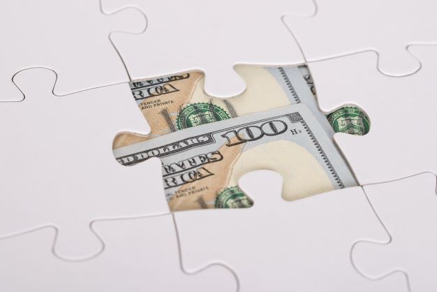 American Banknote Hidden Under Jigsaw